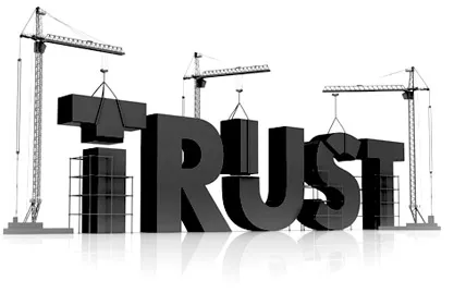 The word TRUST being assembled by construction cranes.